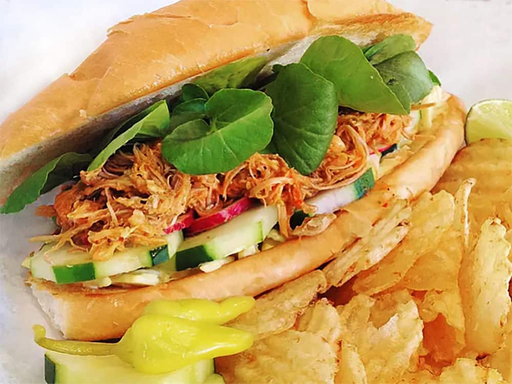 The Pan con Pavo sandwich from gobble This, in Albuquerque, New Mexico. Pulled turkey in a rich Salvadoran mole sauce topped with slaw, cucumber, radish, and fresh watercress, with a side of kettle chips and pickled yellow peppers.