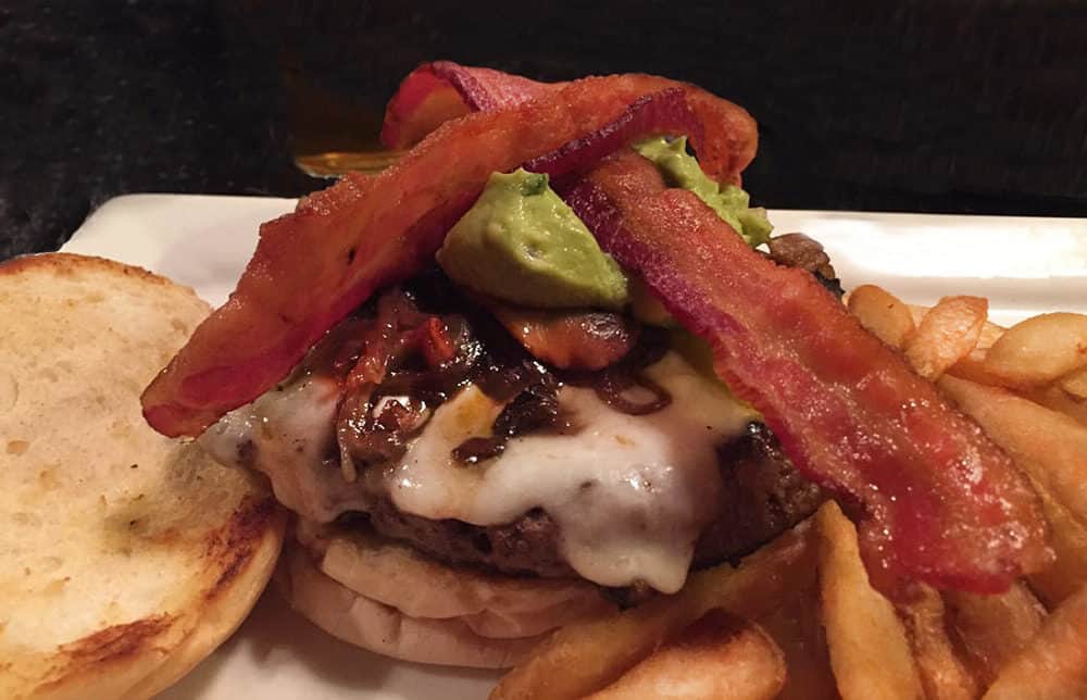 A "Haunted Hamburger" with bacon, cheddar, swiss, mushrooms, green chilies, grilled onions & guacamole in Jerome, AZ