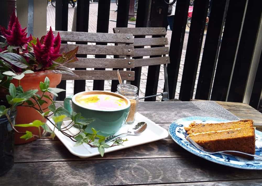 Coffee and carrot cake in the garden at De Koffieschenkerij, snugged up against the walls of the Oude Kerk, the oldest building in Amsterdam.