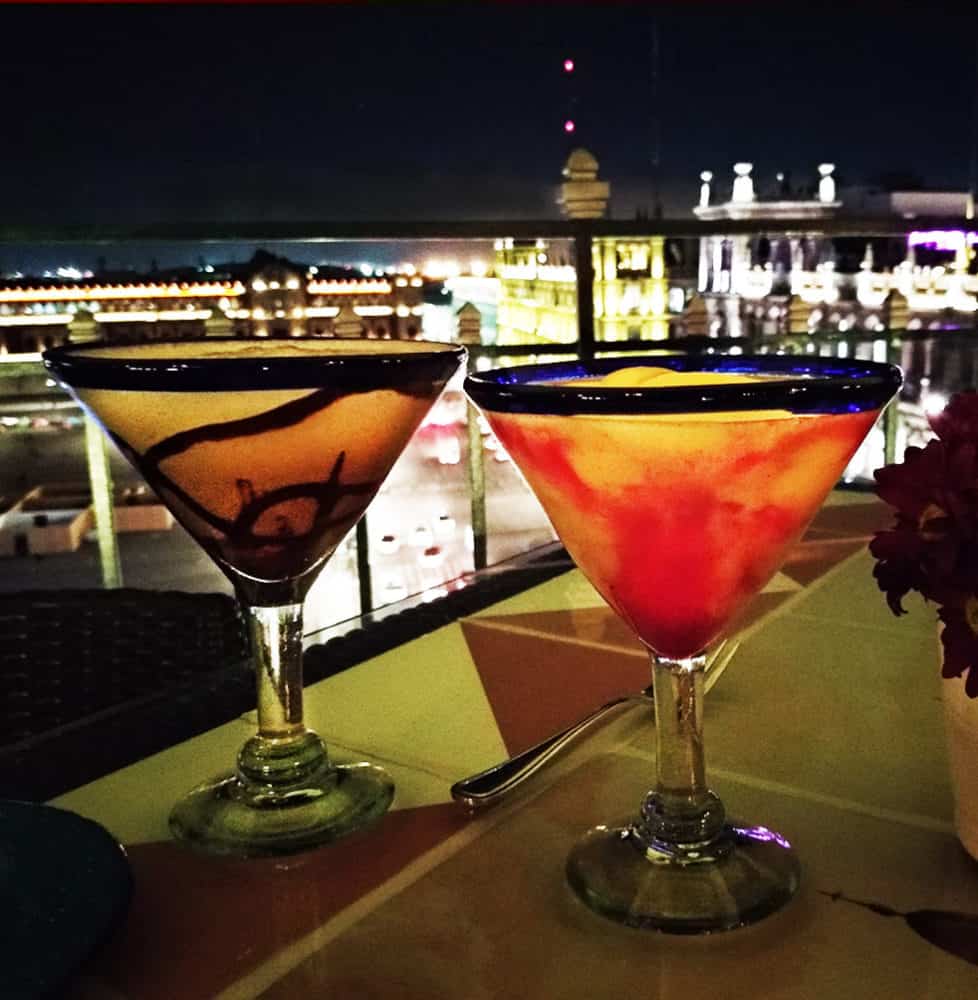 Flavored margaritas with a nighttime view of Mexico City's glorious zocalo, lined with 16th-century buildings at La Terraza rooftop restaurant at the Gran Hotel CDMX.