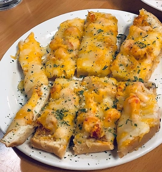 Warm, cheesy bread covered generously with fresh crawfish is a favorite among the appetizers at Luna Bar & Grill in Lake Charles, Louisiana.